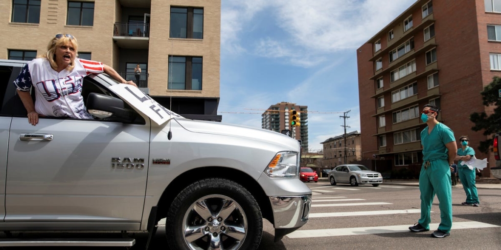 Powerful photos show healthcare workers quietly standing up to anti-lockdown protesters in Denver – Insider